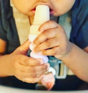 A baby chewing on a teether